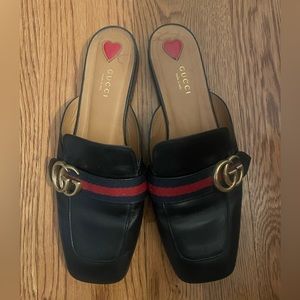 Gucci navy mules with brass Gucci logo